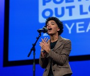 Isavel Mendoza, 2025 National POL Champion, a high school student from Bethlehem, PA, standing on stage, reciting a poem