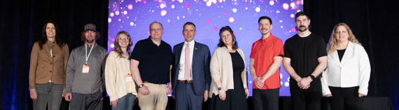 ND Governor Armstrong standing with about a dozen photographers who won awards from the photo contest