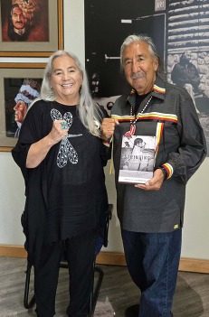 ND Poet Laureate Dr. Denise Lajimodiere gifted Leonard Peltier, a Wahpeton Boarding School survivor, a copy of her book Stringing Rosaries.