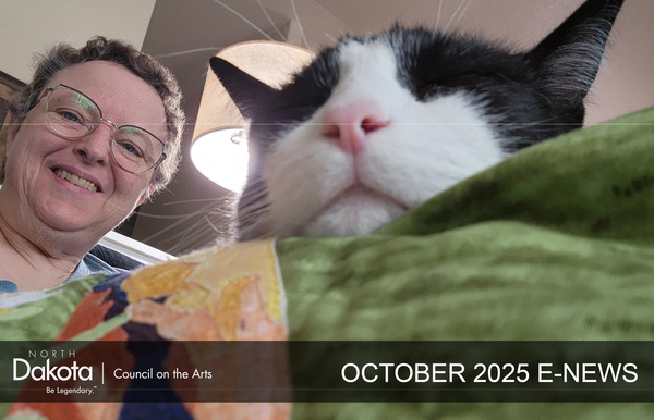Jane Gaffrey creating a quilt with her cat looking on