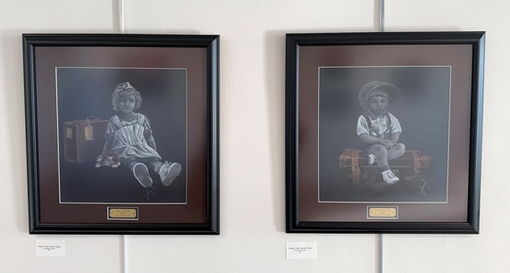 Two soft pastel artworks on paper by Sherry Earl featuring a young girl and boy sitting on vintage suitcases.