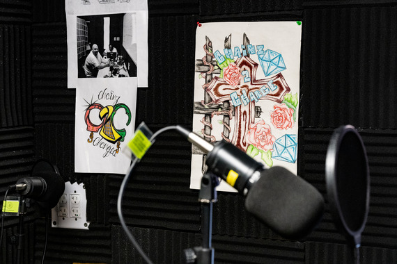 Chainz to Changed artwork on a bulletin board in the background and a podcast microphone in the foreground