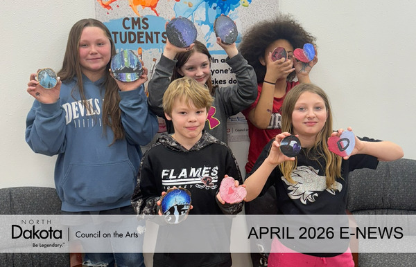 five somewhat diverse middle school students use both hands to hold up their acrylic paintings on rough cut wood rounds with small but proud smiles