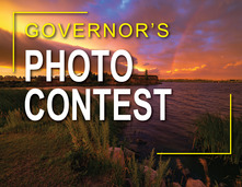 "Governor's Photo Contest" text on top of the 2025 Best of Show winning photo of a sunset storm over lake Sakakawea by Marshall Lipp