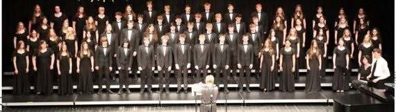 Bottineau High School Concert choir performing on stage in all black