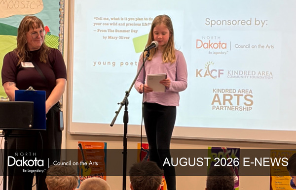 Teaching Artist Anna Paige working with Kindred school students on the Young Poets program, one young girl on a microphone