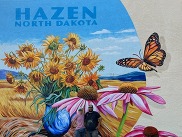 Hazen in Bloom mural with the ladies from Tiger Lily Gold standing underneath