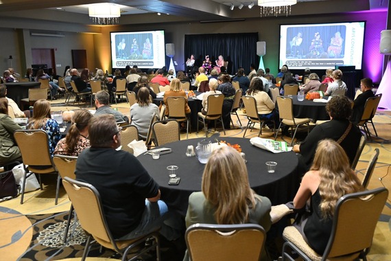 2026 ND Arts Convening Ballroom showing 3 speakers up front and about 10 large tables with 5-8 guests seated at each