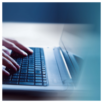 hands typing on a laptop keyboard