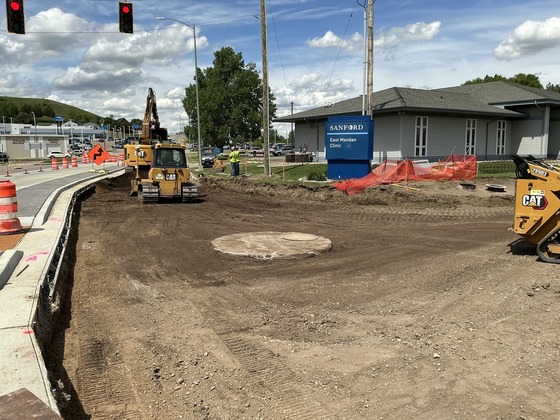 Active construction at the Mandan Avenue and Main Street intersection, with lane closures and equipment visible.