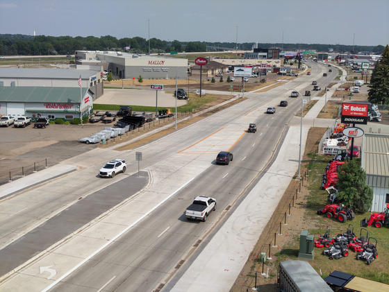East-facing aerial view of completed road construction on Memorial Highway's east end, showing the finished roadway, sidewalks, and signals.