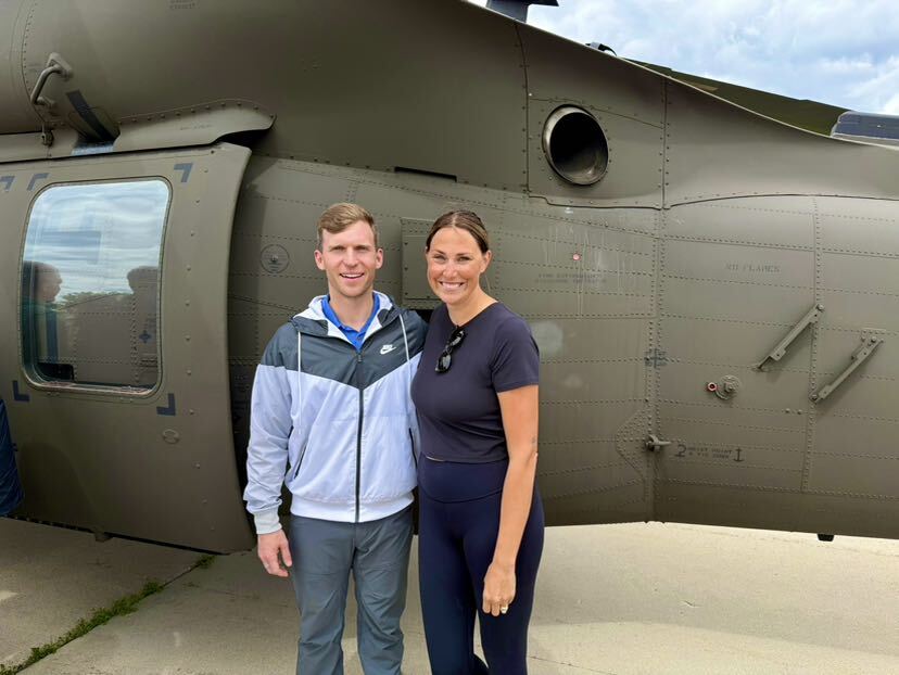 Supt. Bachmeier with Teacher of the Year in front of helicopter for Educators Flight