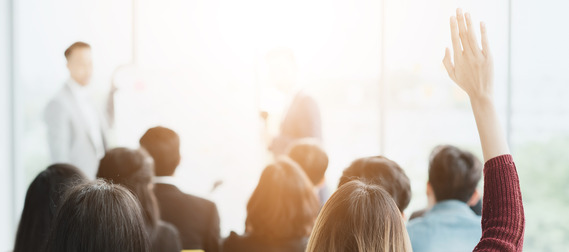 man speaking to group of people