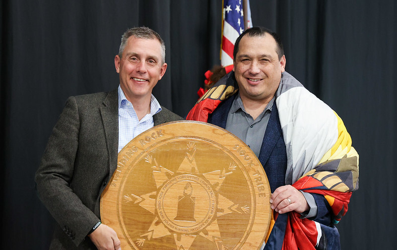 Gov. Armstrong and Standing Rock Chairman Steve Sitting Bear hold an engraved Standing Rock seal gifted to the chairman by the governor