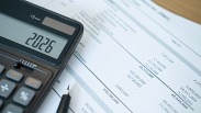 Calculator w/ 2026 and financial paperwork