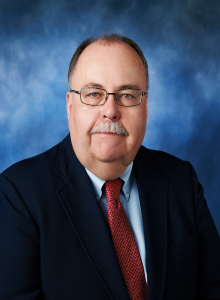 Mike Burton Headshot wearing navy blazer