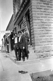Men outside First National Bank in Linton, ND, circa 1920-1930. Click to go to digitalhorizonsonline.org/digital/collection/p16921coll1/id/13896/rec/1