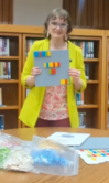 Tammy holding the Lego Braille set