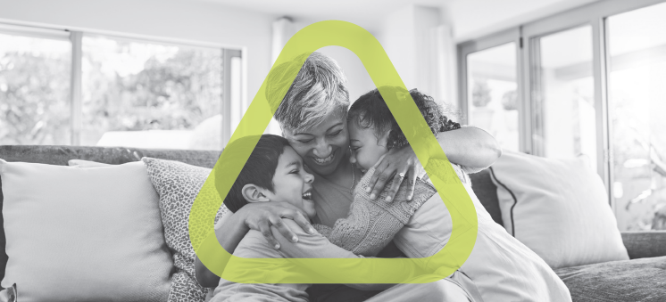 Picture of smiling woman hugging two young children