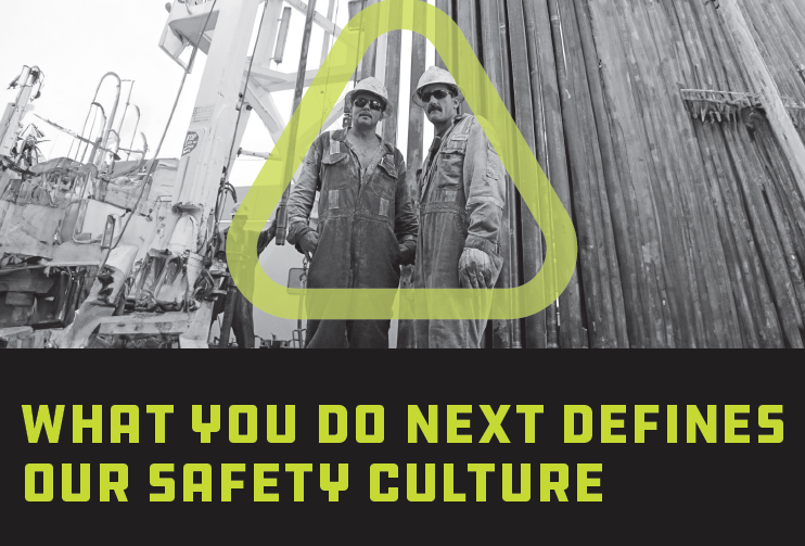 Black and white photo of two oil field workers looking down at camera with the green Get Home Safe triangle around them 