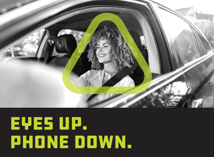 Woman smiling while driving car with seatbelt on