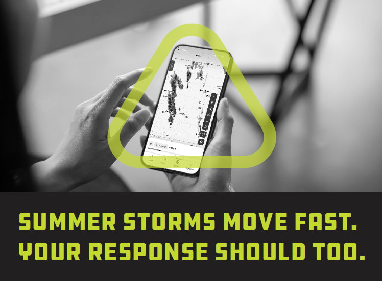 Grayscale phone screen showing weather radar and person's hands holding the phone.