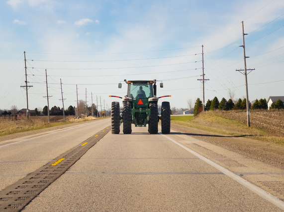 Tractor driving down highway