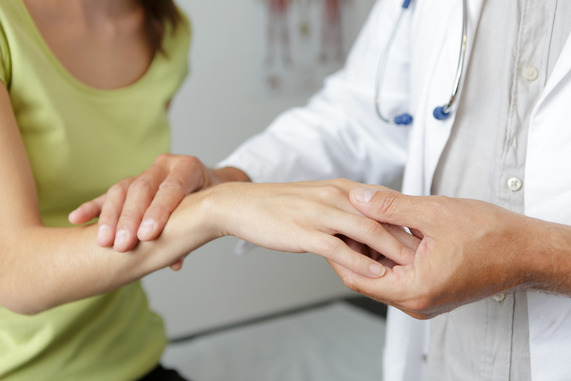 Doctor examining patient's hand