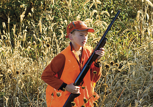 Young boy pheasant hunting