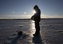 Man ice fishing at Pelican Lake