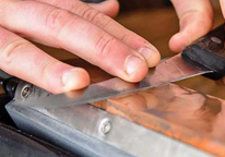 Closeup of a knife being sharpened