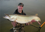 Man holding a master angler muskellunge