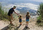 Father fishing with daughters
