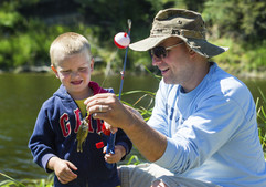 Dad helping son fish