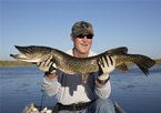 Man holding up a master angler northern pike