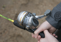 A young person's hands holding a fishing rod