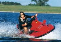 A female conservation officer riding a jet ski