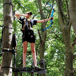 Student shoots bow from tree stand