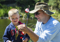 Dad helping his son fish