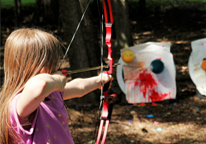 Girl practicing archery outdoors