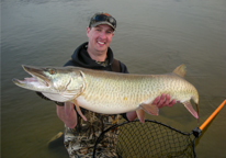 Man holding up a master angler muskellunge