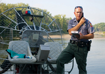 Conservation officer Cory Krause running background checks