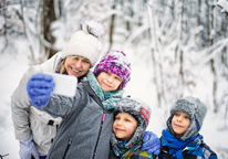 Family taking a selfie in snowy woods