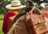 Cowgirl with a saddled horse