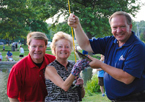 People holding up a fish at Community Fishing Night