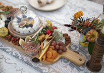 A charcuterie board on a picnic spread