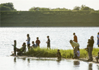 Group of anglers at a Community Fishing Night, fishing from the shore