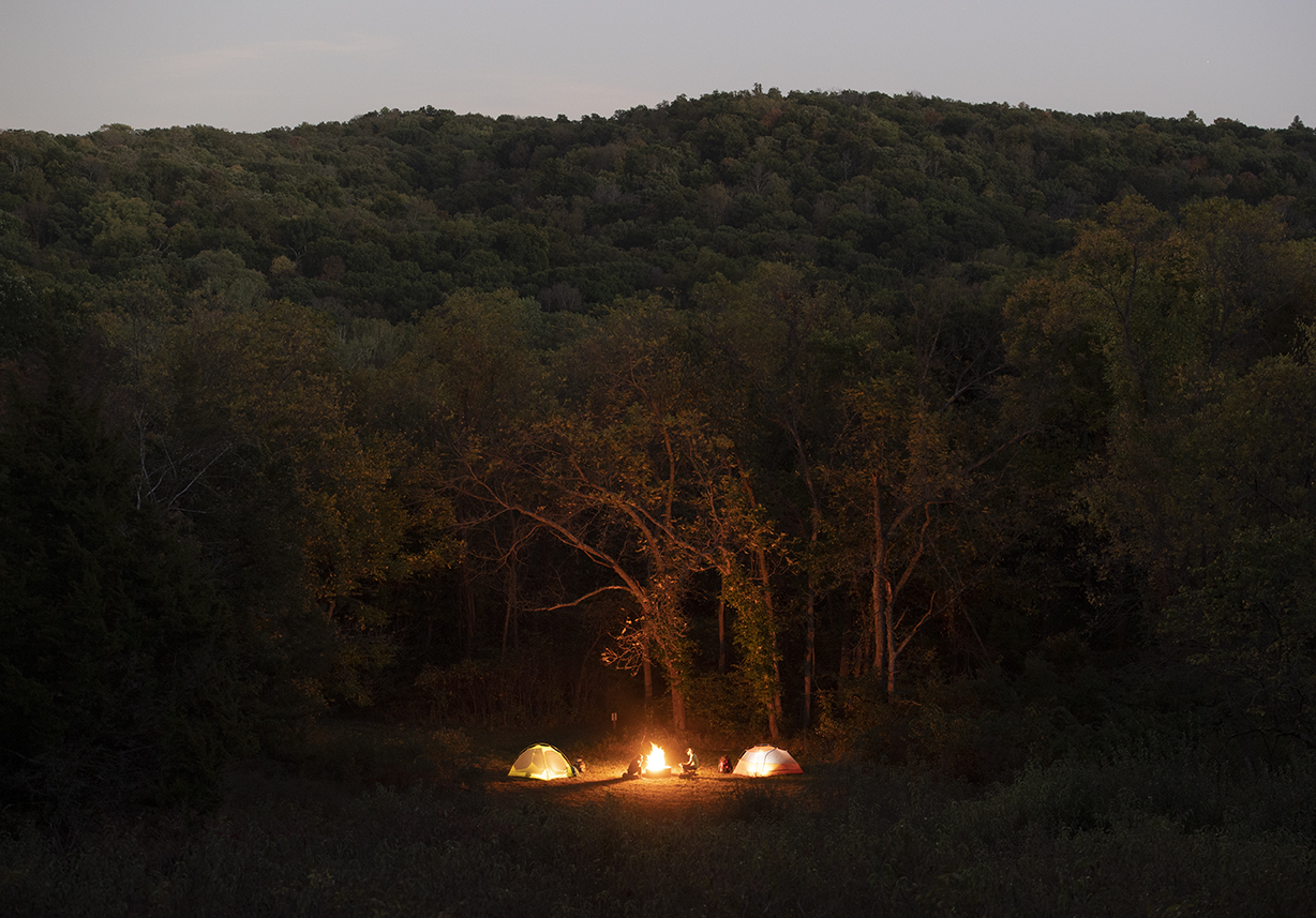 Campfires light up the darkness in the woods at Indian Cave State Park.