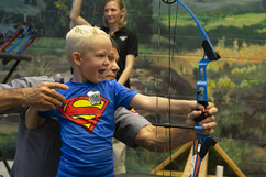 Boy practicing archery at Game and Parks' archery range at the Nebraska state fair