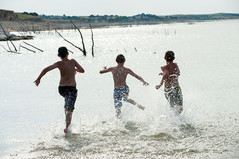 Boys running into the water at Lake McConaughy